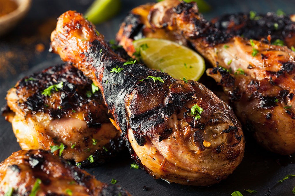 Jerk chicken is traditionally cooked over a fire of green pimento wood and burning coals